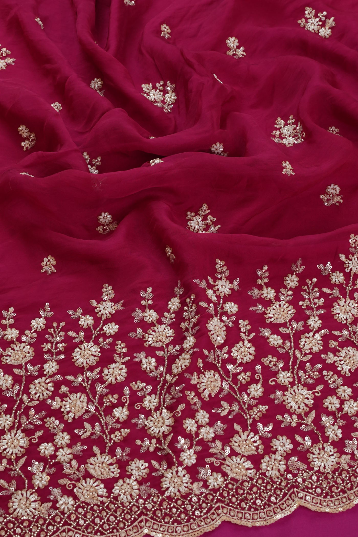 Vibrant Rani Pink Fabric with Intricate Silver Embroidery.