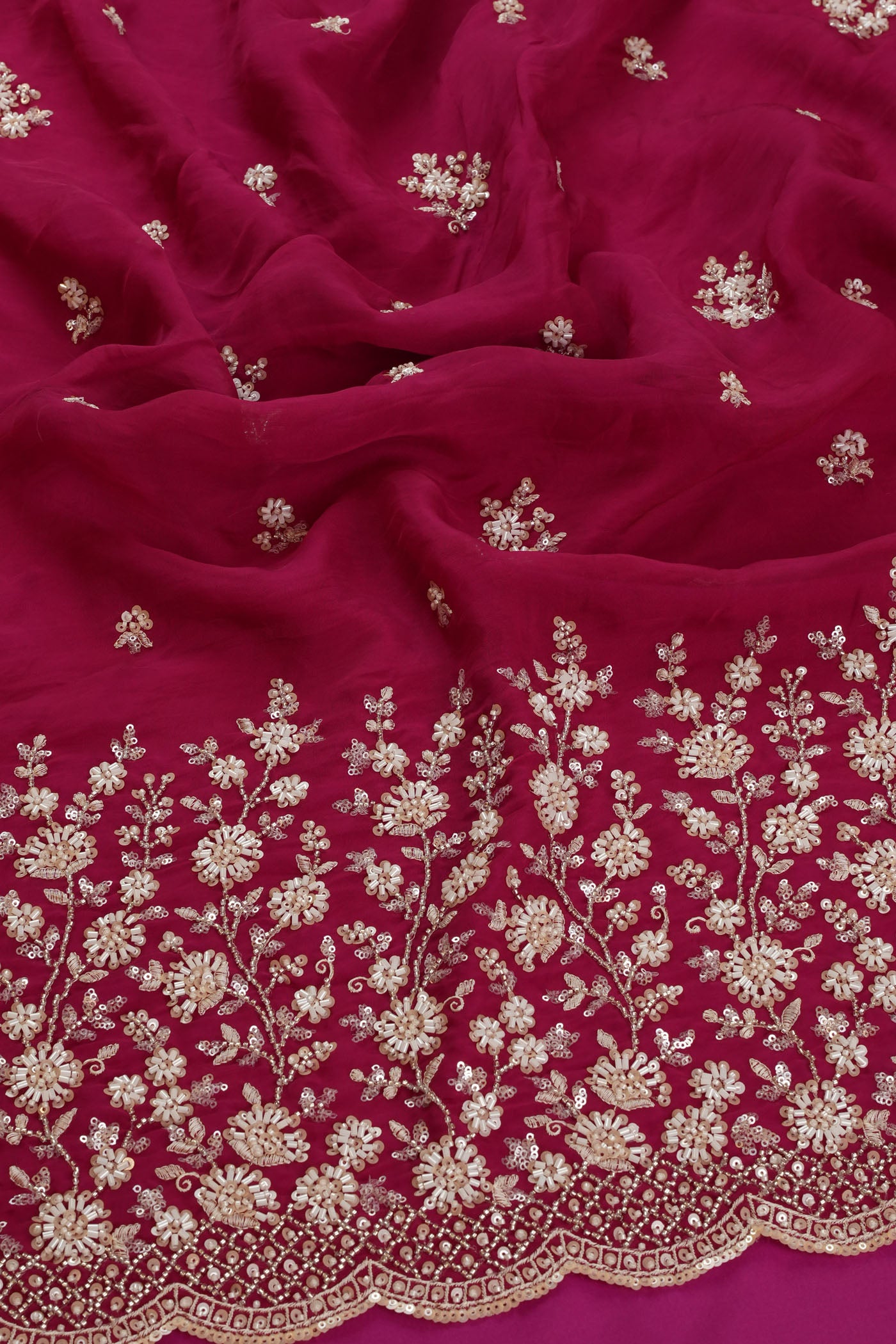 Vibrant Rani Pink Fabric with Intricate Silver Embroidery.
