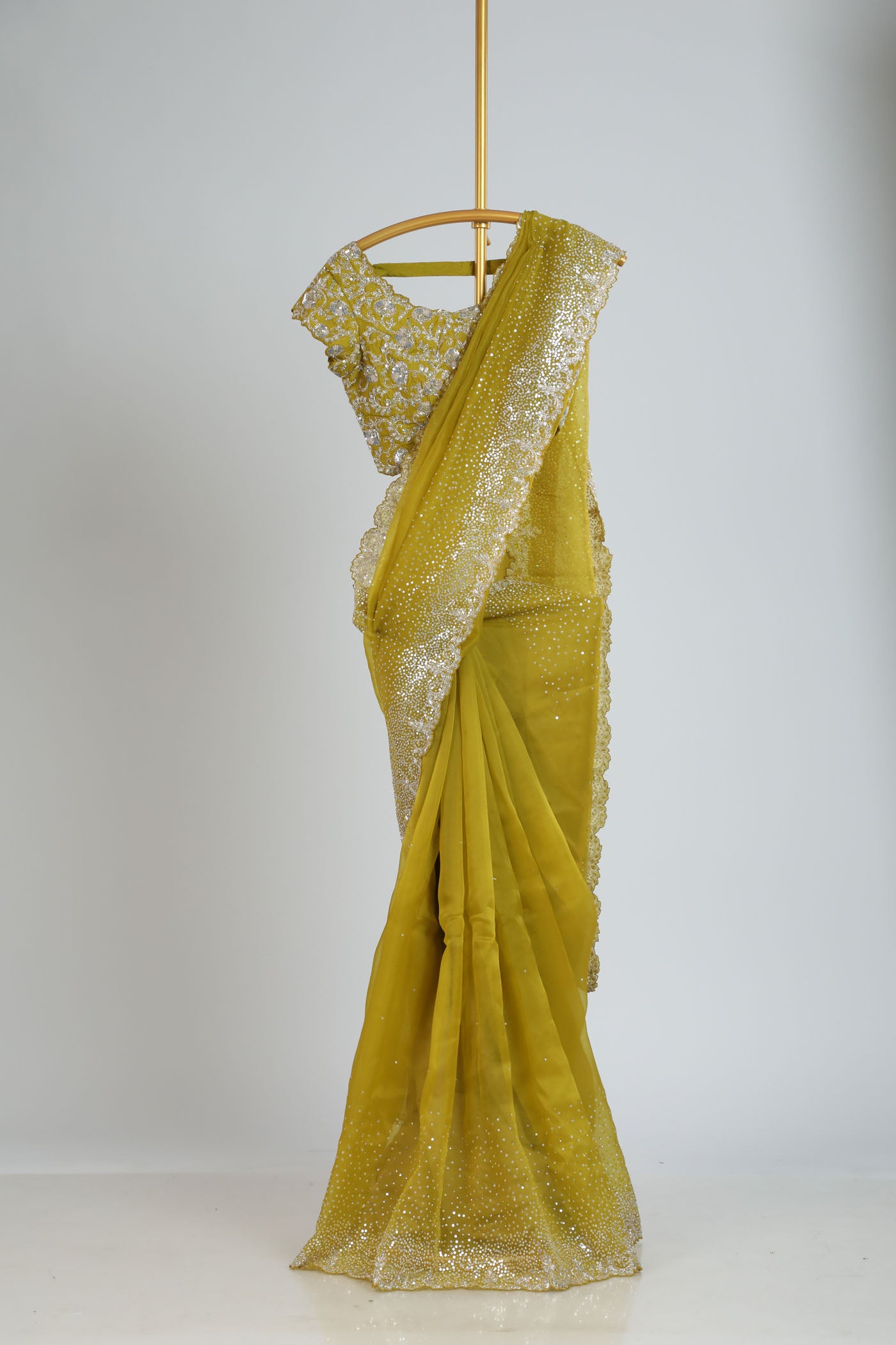 Organza saree with readymade blouse.