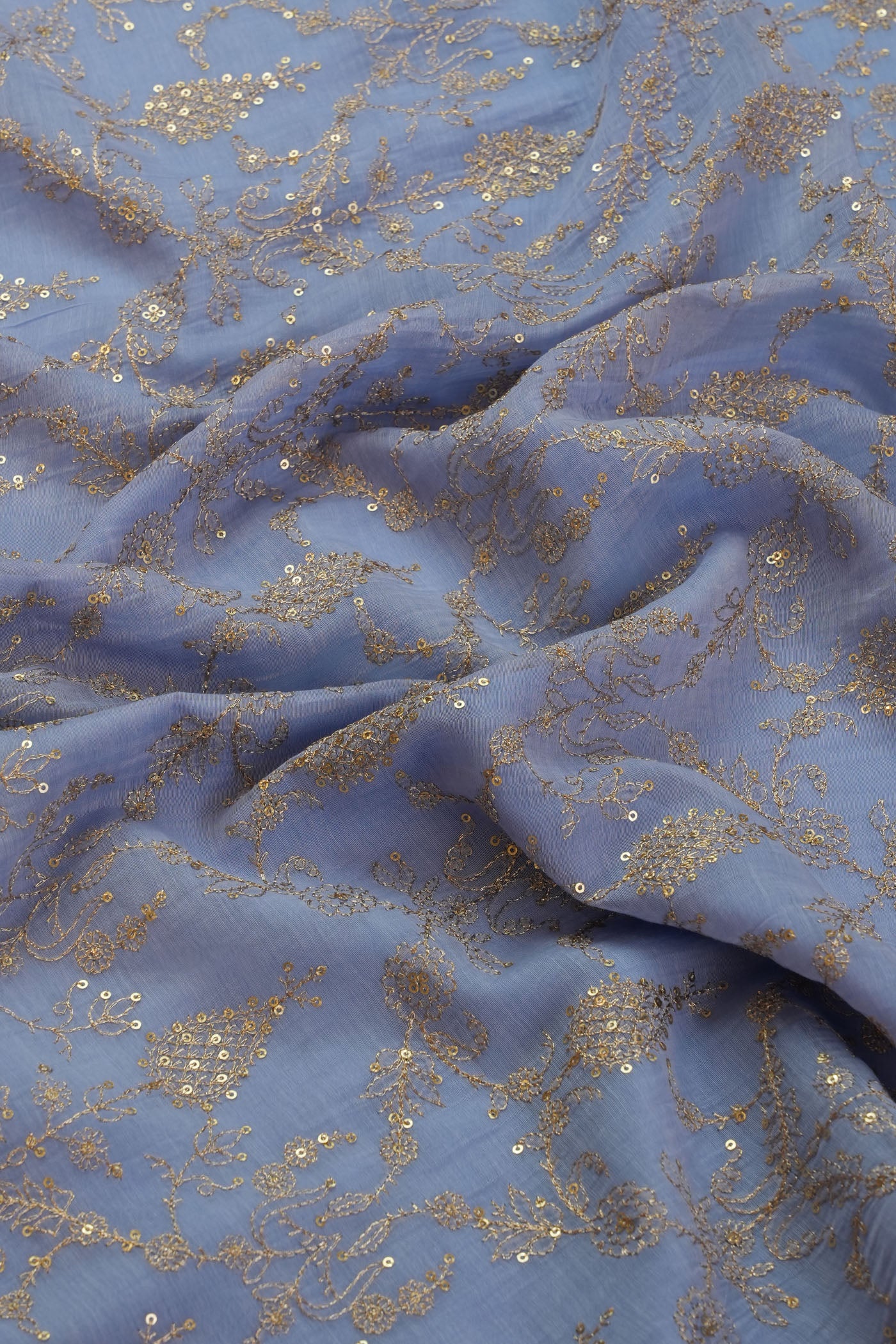 Elegant Blue Embroidered Fabric with Gold Accents.