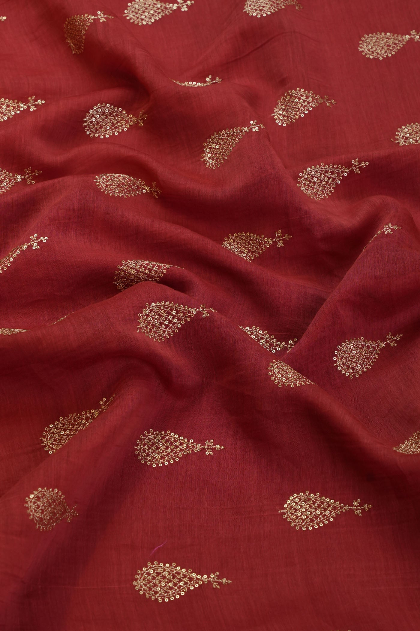 Vibrant Red Silk Fabric with Intricate Gold Embroidery.