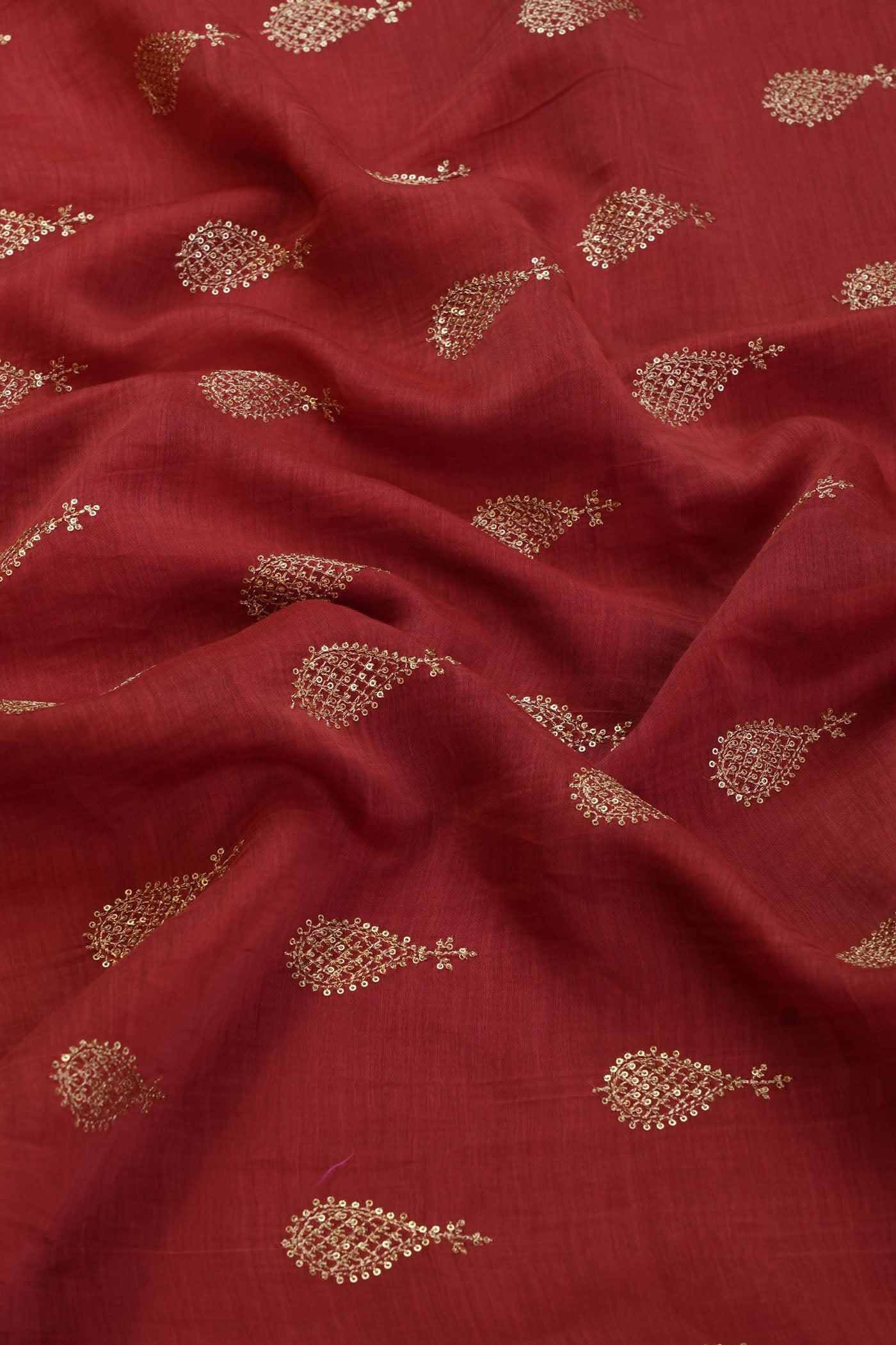 Vibrant Red Silk Fabric with Intricate Gold Embroidery.