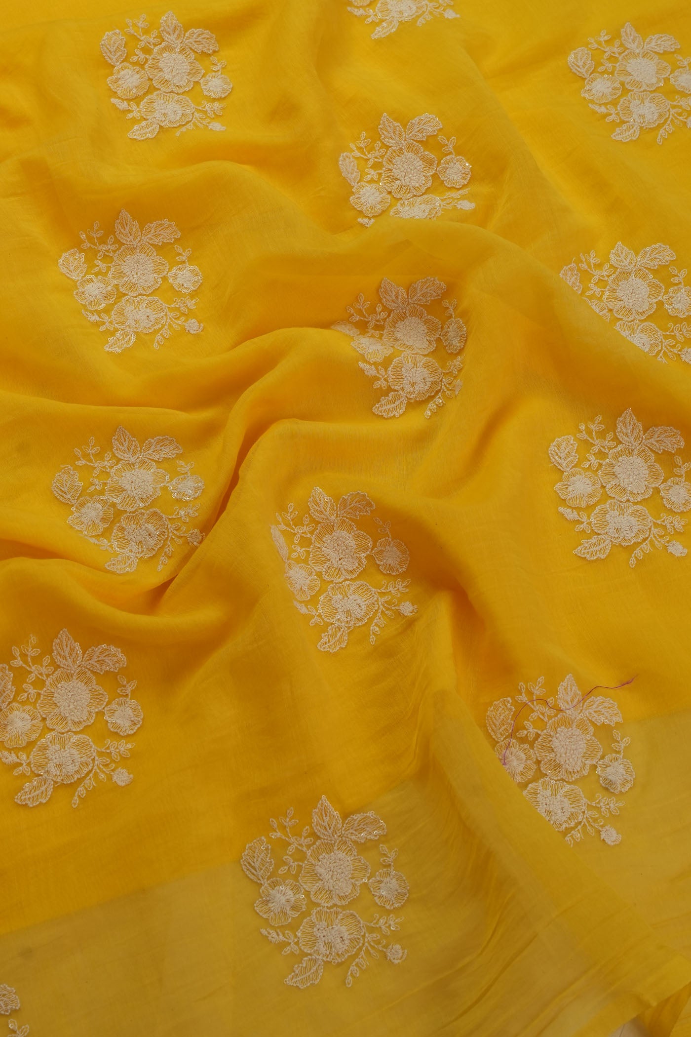 Vibrant Yellow   Fabric with Intricate Floral Embroidery.
