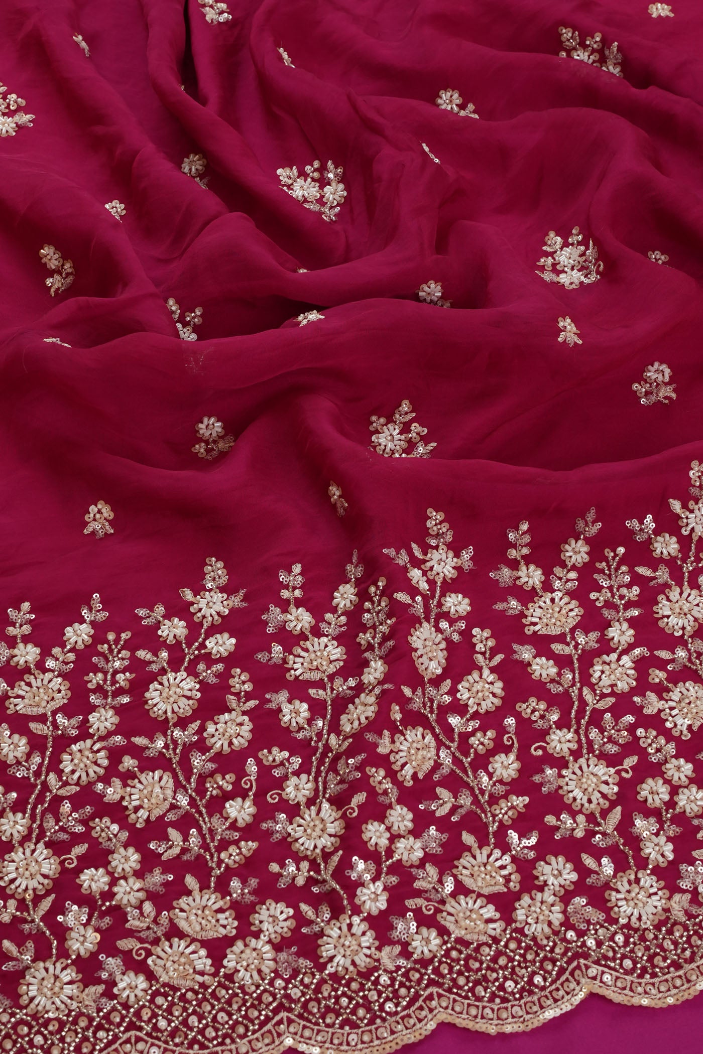Vibrant Rani Pink Fabric with Intricate Silver Embroidery.