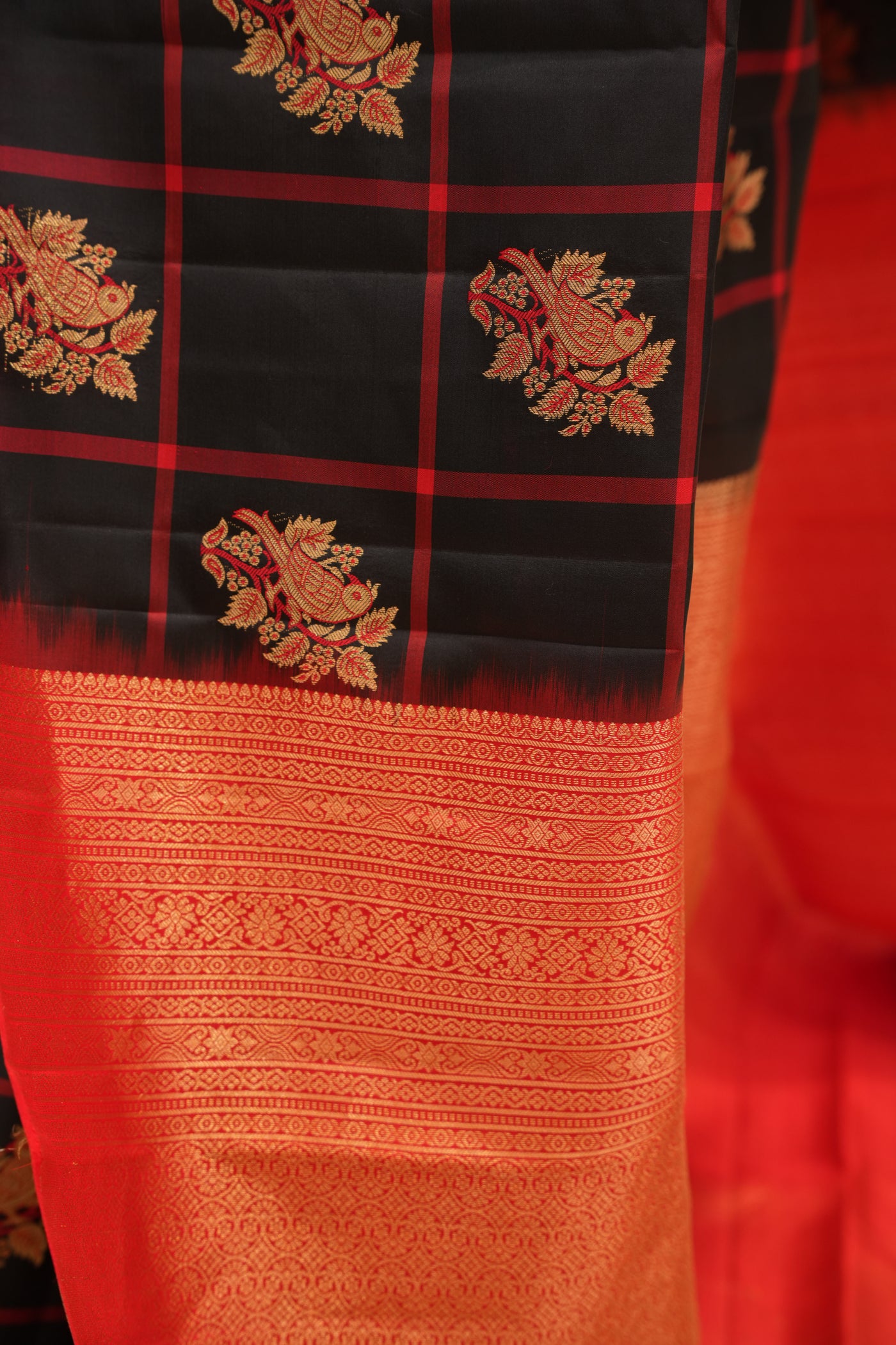 Black & Red Checked Silk Saree that comes along with a contrast pallu